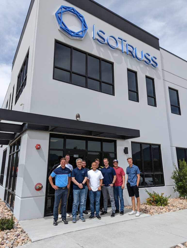 A group of people standing in front of a building.