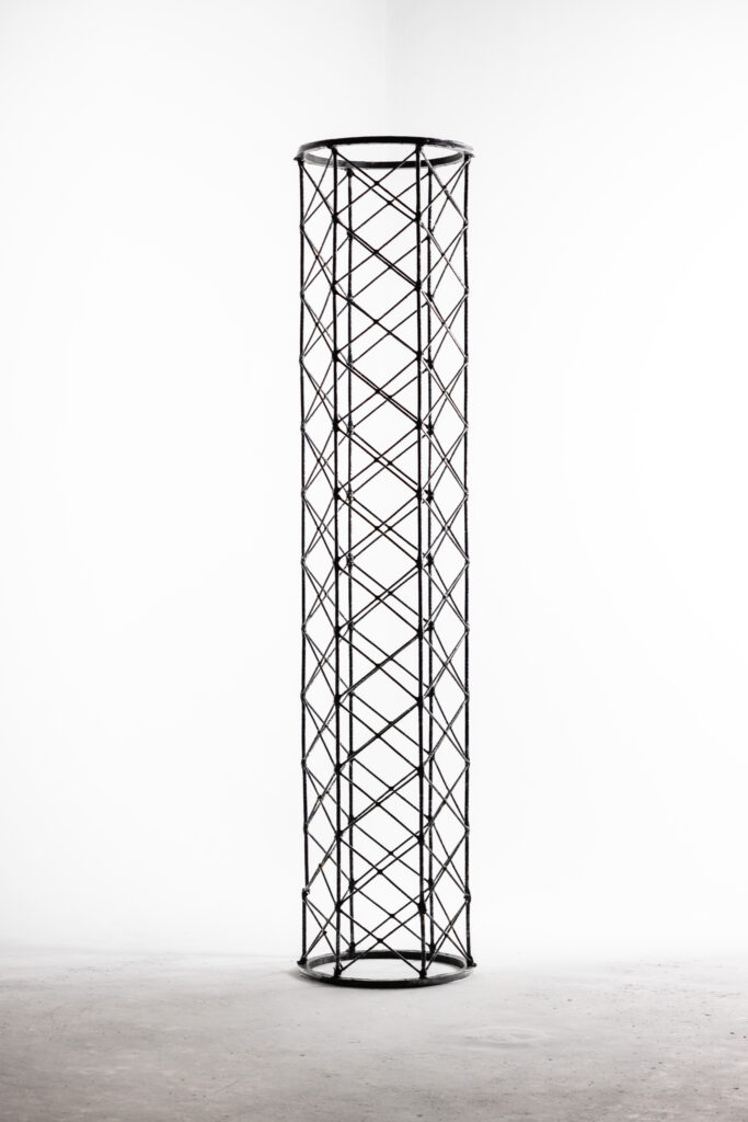 A tall metal tower with a white background