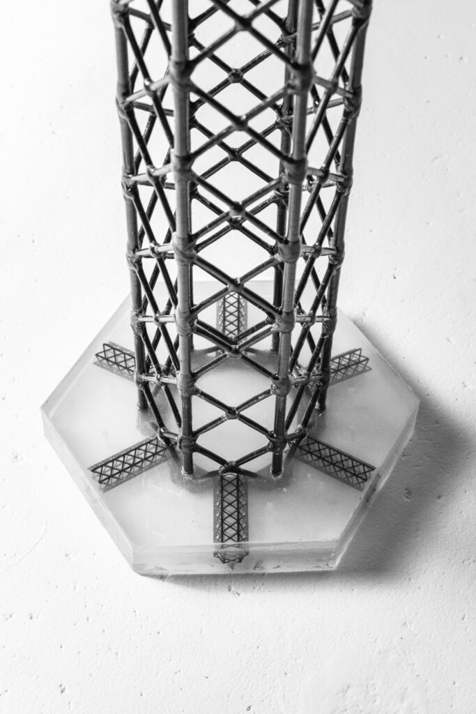A black and white photo of an object in the middle of a tower.